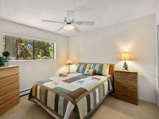 This cozy bedroom features a comfortable bed with a rustic quilt and matching pillows, perfect for a relaxing retreat.