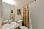 This charming bathroom features a rustic bear-themed shower curtain, adding a touch of nature-inspired design.