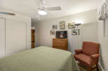 This cozy bedroom features a comfortable bed with a patterned quilt, perfect for a relaxing night's sleep.
