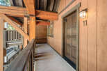 This charming property features a beautifully designed exterior with wooden accents and a welcoming entrance.