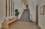 Step into this inviting entryway, showcasing a blend of rustic charm and modern elegance.