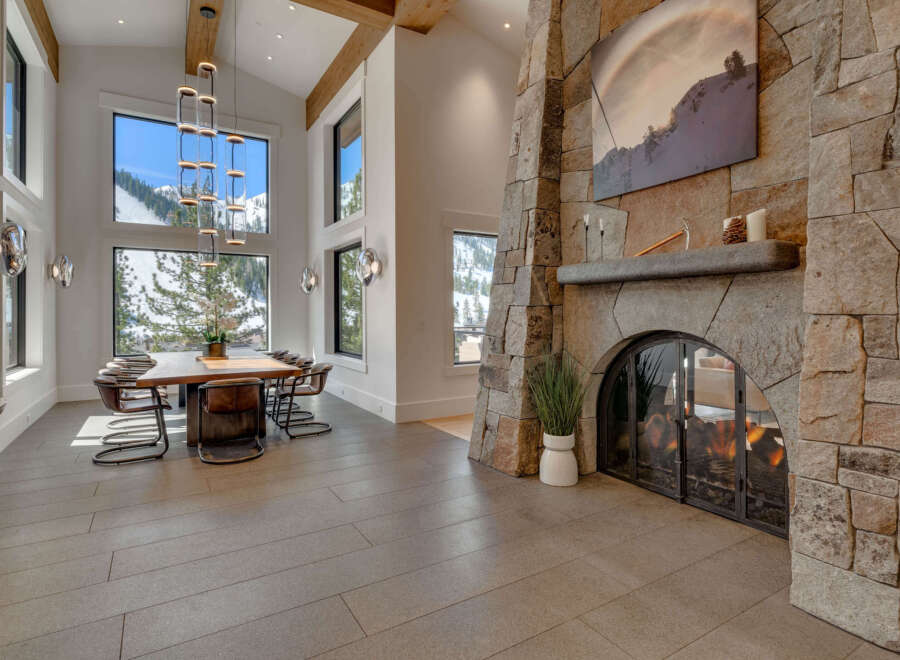Experience luxury living in this stunning property featuring a grand stone fireplace, perfect for cozy evenings.