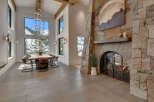 Experience luxury living in this stunning property featuring a grand stone fireplace, perfect for cozy evenings.
