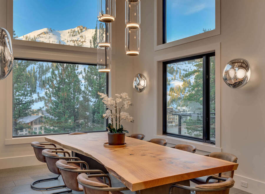Experience luxury living in this stunning property, featuring a dining area with breathtaking mountain views.