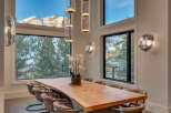 Experience luxury living in this stunning property, featuring a dining area with breathtaking mountain views.