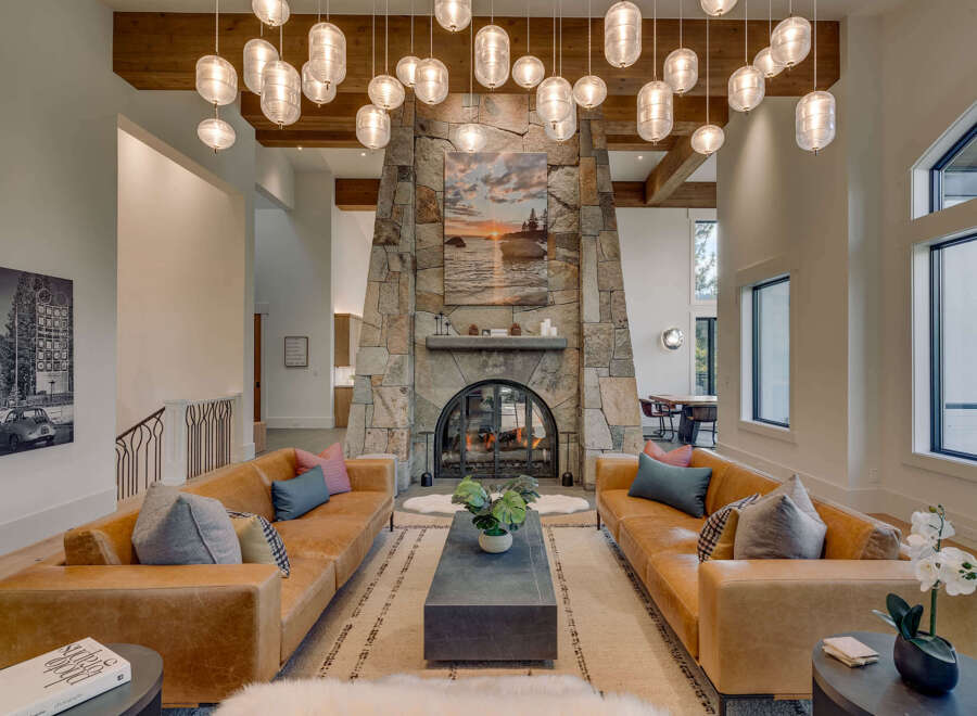 Experience luxury living in this stunning property featuring a grand stone fireplace, perfect for cozy evenings.