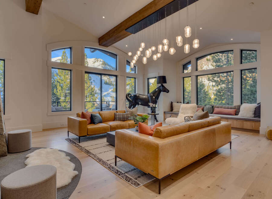 Experience luxury living in this stunning property featuring a spacious living room with breathtaking mountain views.