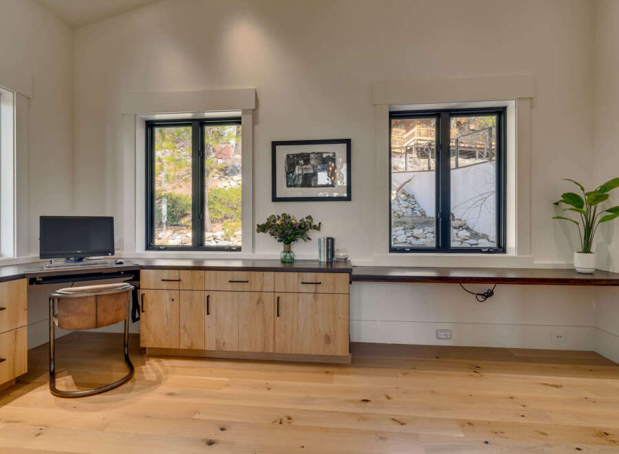 This stunning home office features a sleek, modern design with ample natural light.