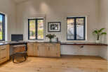 This stunning home office features a sleek, modern design with ample natural light.