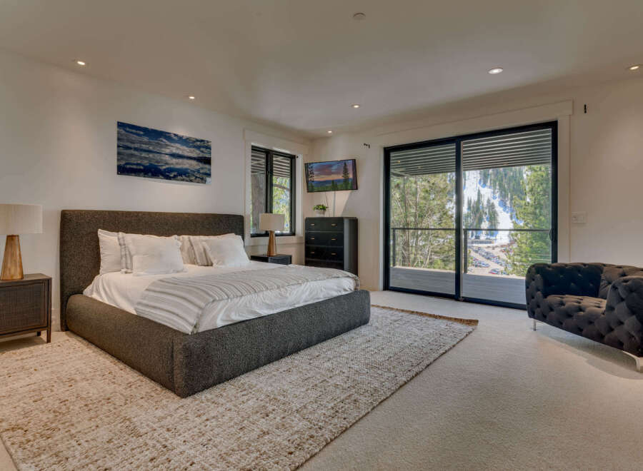 This luxurious bedroom offers a serene retreat with its modern design and stunning views.