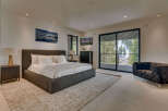 This luxurious bedroom offers a serene retreat with its modern design and stunning views.