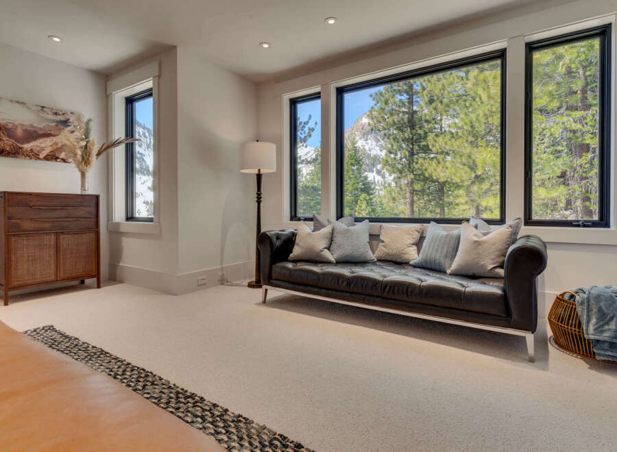Experience luxury living in this stunning property, featuring a spacious living room with breathtaking mountain views.