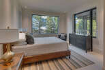Experience luxury living in this stunning bedroom with breathtaking mountain views.