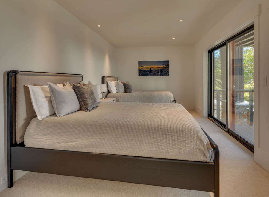 This luxurious bedroom features two comfortable beds, perfect for guests or a spacious master suite.