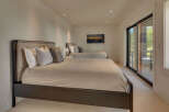 This luxurious bedroom features two comfortable beds, perfect for guests or a spacious master suite.