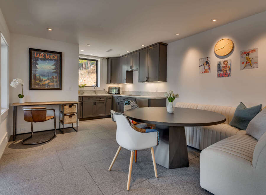 This stunning property features a modern kitchen with sleek cabinetry and a cozy dining area.