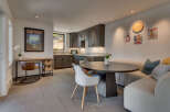 This stunning property features a modern kitchen with sleek cabinetry and a cozy dining area.