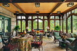 Step into a world of refined elegance with this stunning sunroom, offering a seamless blend of indoor comfort and outdoor beauty.