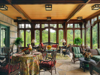 Step into a world of refined elegance with this stunning sunroom, offering a seamless blend of indoor comfort and outdoor beauty.