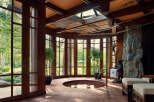 This luxurious spa room features a stunning design with a natural stone pillar and a built-in hot tub.
