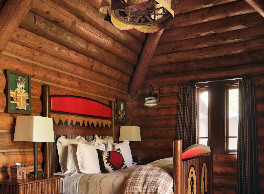 Step into rustic elegance in this stunning log cabin bedroom.