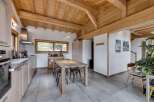 This stunning property boasts a beautifully designed kitchen with a wooden ceiling, creating a warm and inviting atmosphere.