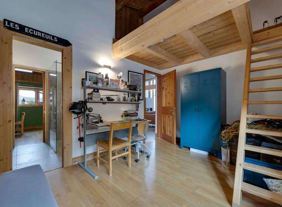 Discover this charming property featuring a cozy study area with a desk and shelving, perfect for work or hobbies.