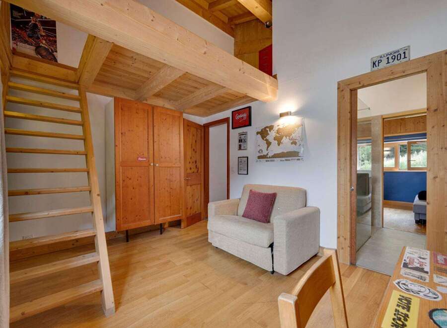 Discover the charm of this cozy property, featuring a unique loft space with wooden beams and a convenient ladder.