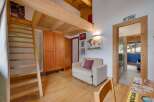 Discover the charm of this cozy property, featuring a unique loft space with wooden beams and a convenient ladder.