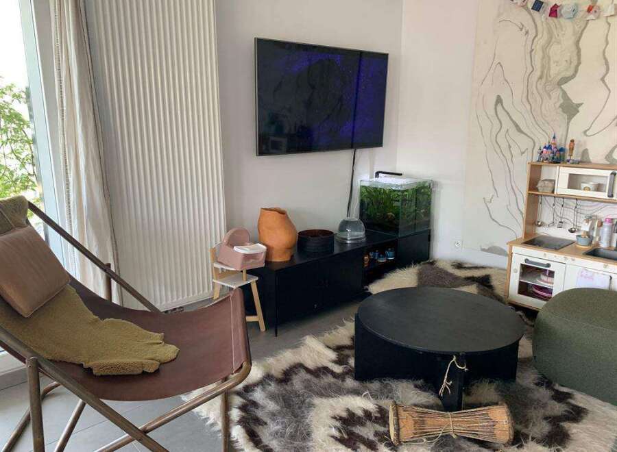 This cozy living space features a stylish combination of modern and bohemian elements.
