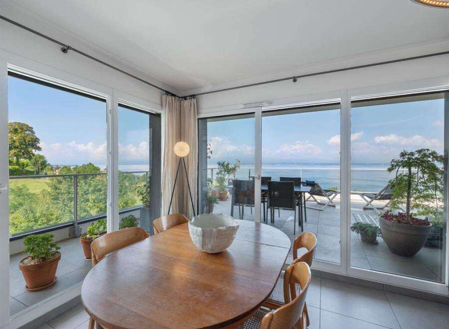 Experience breathtaking views from this stunning property, featuring expansive windows that frame the serene water and lush greenery.
