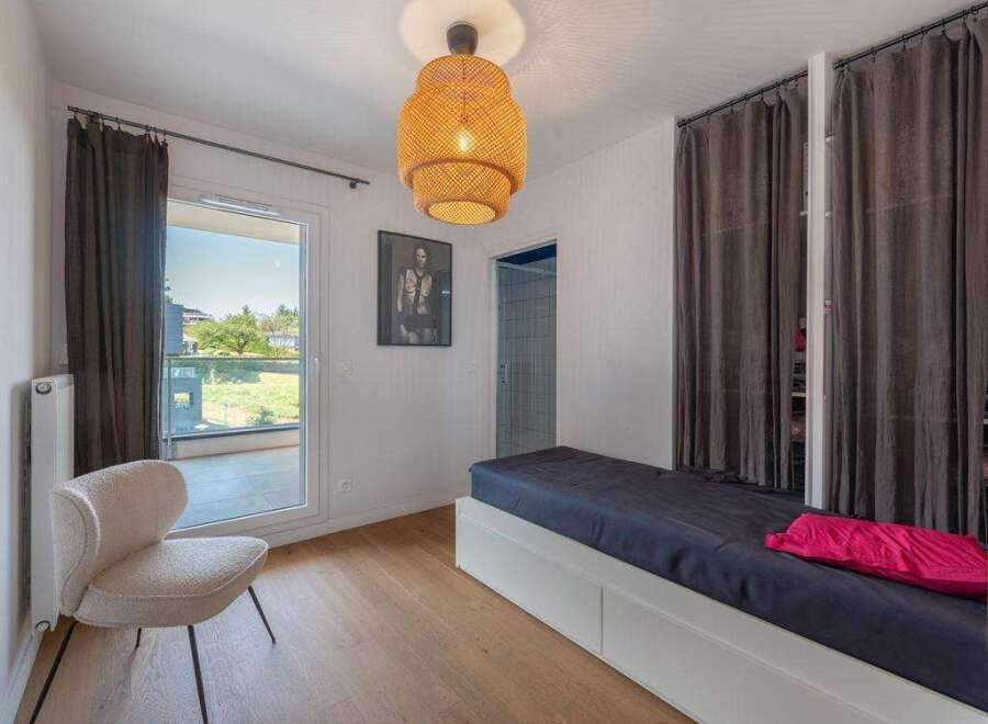 Discover this inviting bedroom featuring a stylish design and ample natural light.