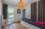 Discover this inviting bedroom featuring a stylish design and ample natural light.