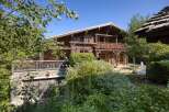 Discover the charm of this stunning wooden chalet, nestled amidst lush greenery.