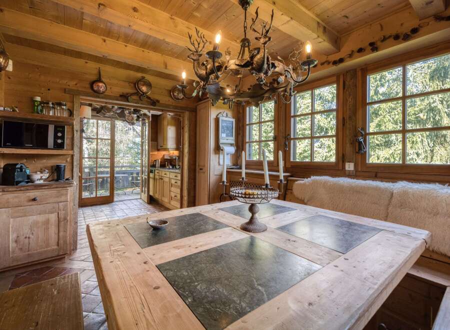 This charming dining room features a rustic wooden table with stone inlays, perfect for family gatherings.