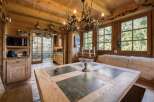 This charming dining room features a rustic wooden table with stone inlays, perfect for family gatherings.