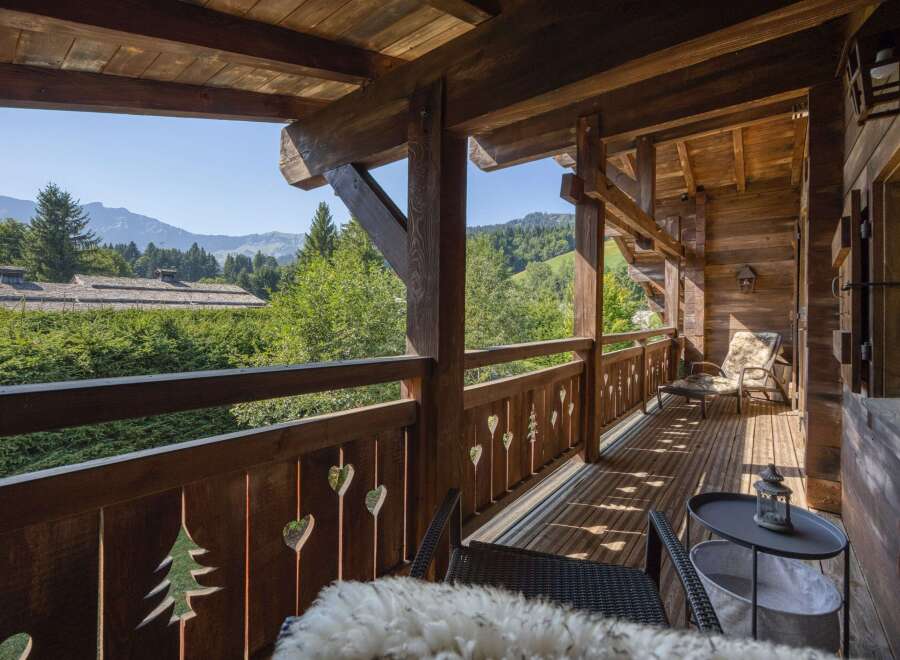 Experience the tranquility of mountain living from this stunning wooden balcony.