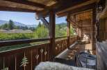 Experience the tranquility of mountain living from this stunning wooden balcony.