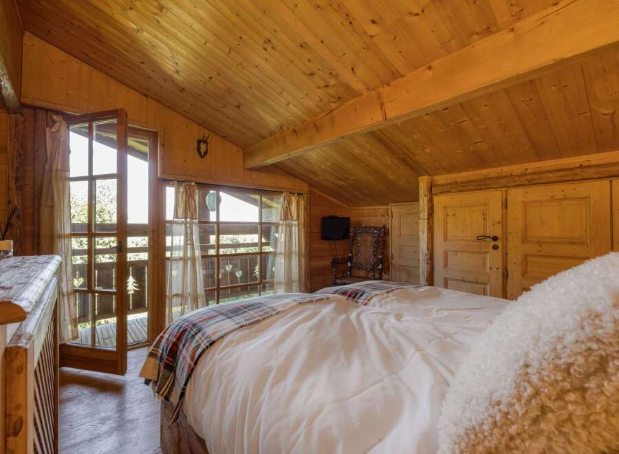 This cozy bedroom features a rustic wooden interior, creating a warm and inviting atmosphere.