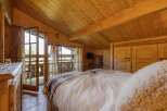 This cozy bedroom features a rustic wooden interior, creating a warm and inviting atmosphere.