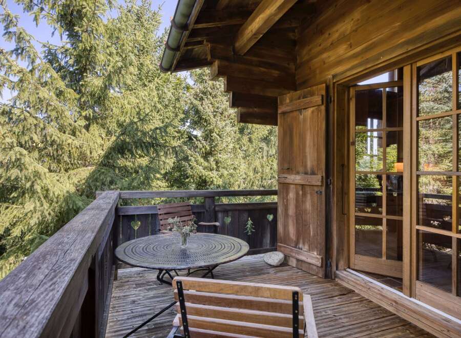 Enjoy the tranquility of this charming wooden balcony, perfect for relaxing and taking in the surrounding natural beauty.