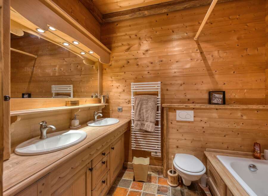 This rustic bathroom features beautiful wooden paneling, creating a warm and inviting atmosphere.