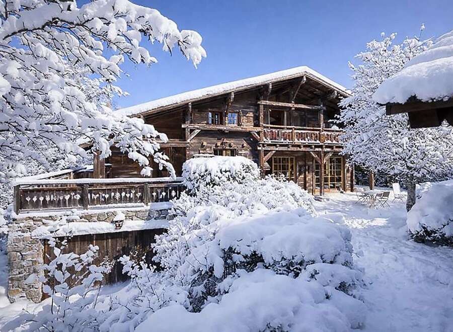 Experience the charm of this stunning wooden chalet nestled in a winter wonderland.