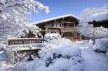 Experience the charm of this stunning wooden chalet nestled in a winter wonderland.