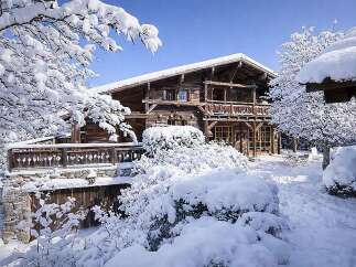 Experience the charm of this stunning wooden chalet nestled in a winter wonderland.