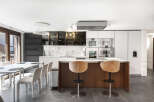 This modern kitchen boasts a sleek design with high-end appliances and a spacious island.