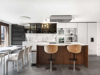 This modern kitchen boasts a sleek design with high-end appliances and a spacious island.