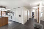 This modern kitchen boasts sleek, white cabinetry and integrated appliances, creating a seamless and stylish design.