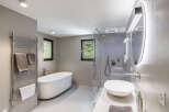 Step into a luxurious bathroom oasis, featuring a sleek, modern design.