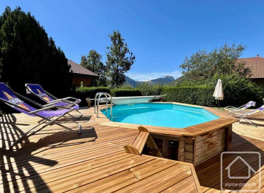 Enjoy the ultimate relaxation in this stunning property featuring a private pool and a spacious wooden deck.